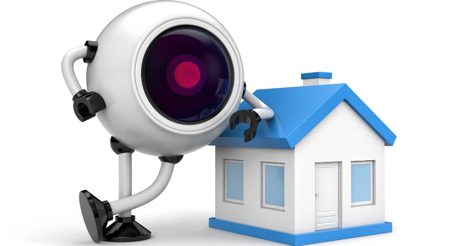Image of a jhome security robot next to a house.